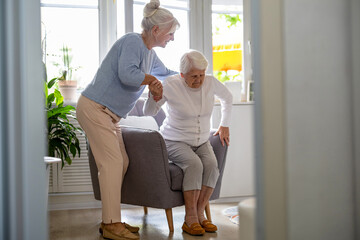 Elderly woman with her caregiver at nursing home
