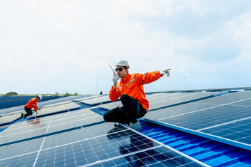 engineer man inspects construction of solar cell panel or photovoltaic cell by electronic device. Industrial Renewable energy of green power. factory worker working on tower roof.