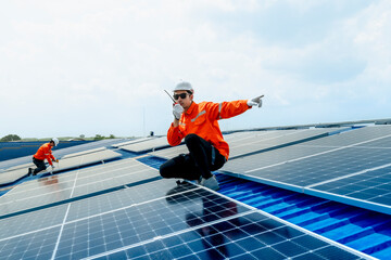 engineer man inspects construction of solar cell panel or photovoltaic cell by electronic device....