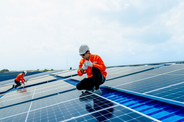 engineer man inspects construction of solar cell panel or photovoltaic cell by electronic device....