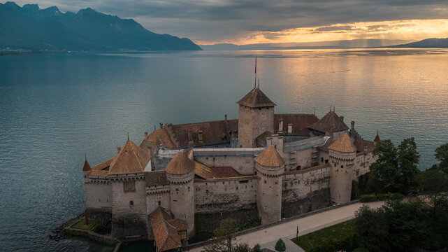 Chateau Chillon Castle in Switzerland, dramatic sunset over Lake Geneva