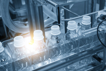 The  empty drinking water bottles  on the conveyor belt for filling process.