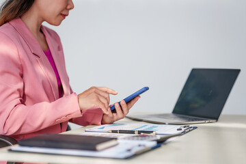 40-year-old middle-aged Asian businesswoman wearing pink suit, business finance, investment...