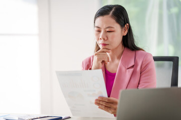 40-year-old middle-aged Asian businesswoman wearing pink suit, business finance, investment...