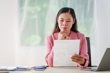 40-year-old middle-aged Asian businesswoman wearing pink suit, business finance, investment...