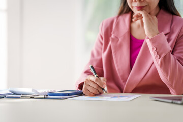 40-year-old middle-aged Asian businesswoman wearing pink suit, business finance, investment...