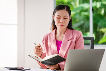 40-year-old middle-aged Asian businesswoman wearing pink suit, business finance, investment...