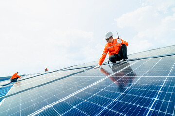 engineer man inspects construction of solar cell panel or photovoltaic cell by electronic device....