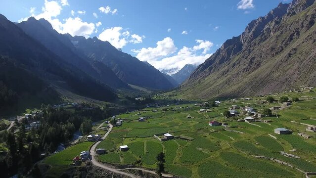 Aerial view of Majestic Naltar Valley surrounded by Rugged Mountains and Lush Greenery, Gilgit, Pakistan.