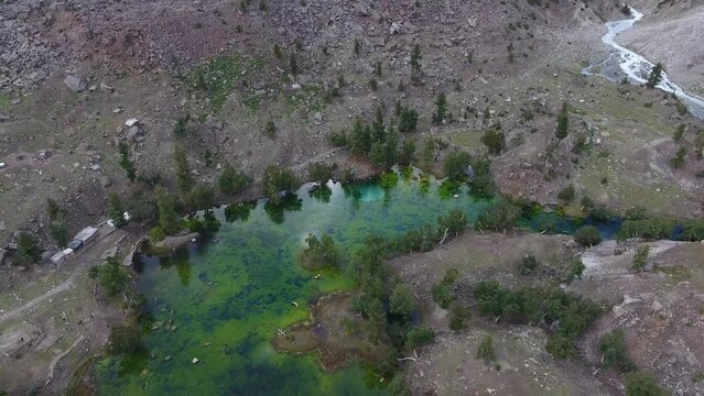Aerial view of Naltar Valley with pristine lake, majestic mountains, and tranquil forest, Gilgit, Pakistan.