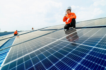 engineer man inspects construction of solar cell panel or photovoltaic cell by electronic device....
