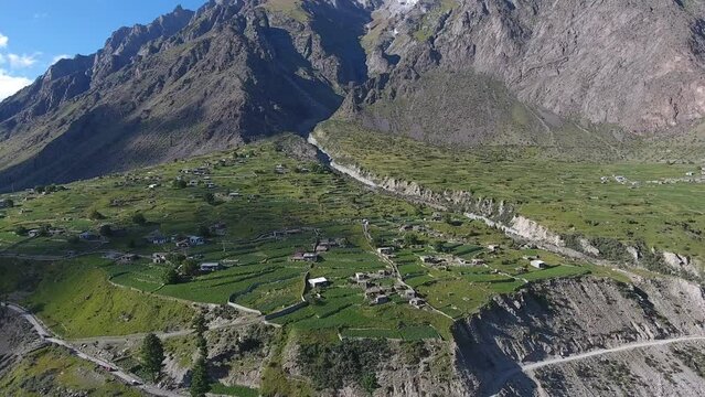 Aerial view of serene Naltar Valley with remote village and terraced fields, Gilgit-Baltistan, Pakistan.