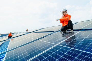 engineer man inspects construction of solar cell panel or photovoltaic cell by electronic device....