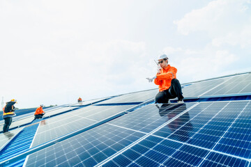 Fototapeta na wymiar engineer man inspects construction of solar cell panel or photovoltaic cell by electronic device. Industrial Renewable energy of green power. factory worker working on tower roof.