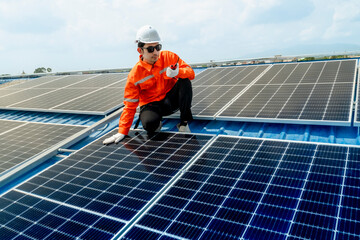 engineer man inspects construction of solar cell panel or photovoltaic cell by electronic device. Industrial Renewable energy of green power. factory worker working on tower roof.