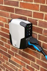 Electric vehicle charging station attached to a residential building