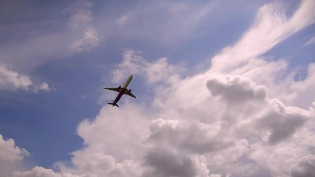 Jet plane approaching landing across blue sky