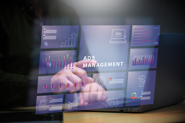 ADS Management , Manager using laptop to manage advertise project to get a high efficiency result.