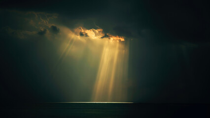 Light of Faith. Dramatic sunset over the sea with rays of golden light and clouds.