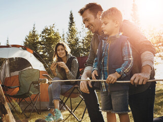 Family, camping and smores outdoor in nature for bonding with love, happiness and relax in forest with affection. Mother, father and son together for adventure in wilderness, peace and summer trip.