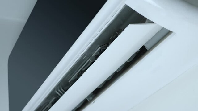 Close-up shot indoor unit air conditioning swinging wing