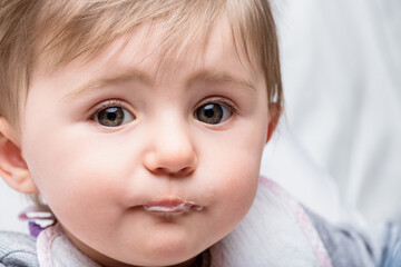 Adorable baby girl making a funny face and drooling