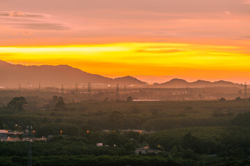 Background of trees growing along the sea coast, rain clouds covering and wind blowing blurred during the rainy season at the Noen Nang Phaya viewpoint, Chanthaburi, Thailand.