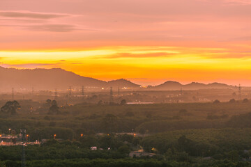 Background of trees growing along the sea coast, rain clouds covering and wind blowing blurred during the rainy season at the Noen Nang Phaya viewpoint, Chanthaburi, Thailand.
