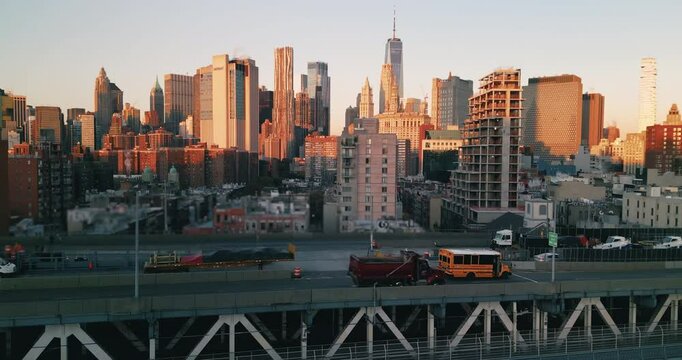 Drone rising above epic urban landscape of busy New York City life during beautiful pink sunrise