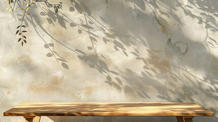 beige wall with texture and tree shadows, wooden table against the wall