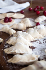 Cooking homemade varenyky (dumplings) with cherry. Ukrainian national quisine