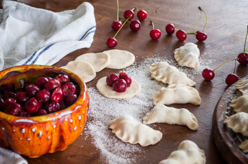 Cooking homemade varenyky (dumplings) with cherry. Ukrainian national quisine