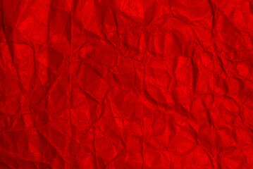 A sheet of red wrinkled paper texture as background