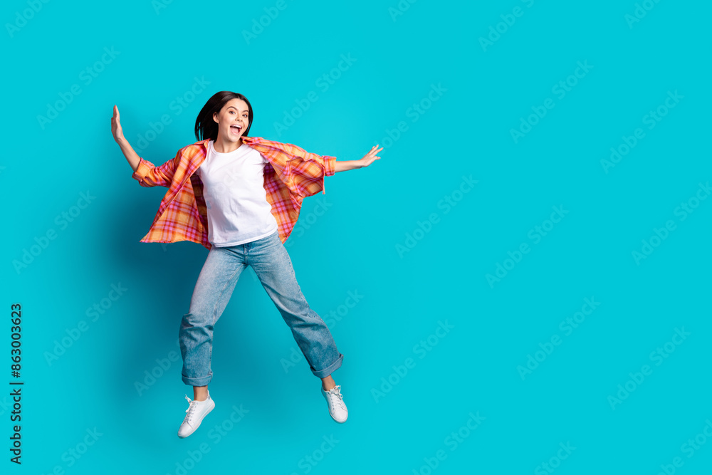 Poster full body portrait of nice girl jump empty space wear checkered shirt isolated on turquoise color ba