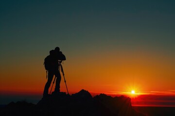 Photographer silhouette against sunset background.