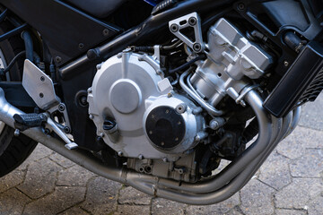 Close-up view of a silver motorcycle engine.