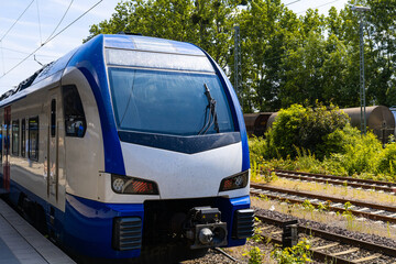 Naklejka premium Front view of a passenger electric train standing on the platform.