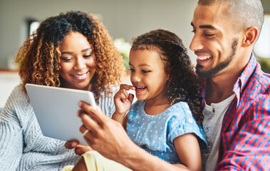 Fototapeta premium Tablet, happy family and kid with parents in living room together for learning, education or relax. Girl, mom and father on digital technology to watch funny comedy movie, cartoon and game in home