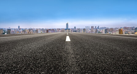 Open Road Leading to Urban Skyline