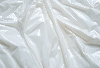Obraz premium Crinkled clear plastic sheet with light reflecting off its surface.