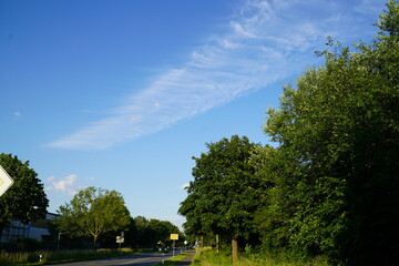 Chemtrail Clouds against a blue sky. Chemtrails and contrails aerial spraying over the city of...