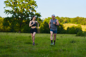 Fitness couple jogging in the forest