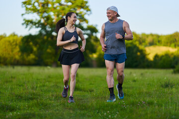 Fitness couple jogging in the forest