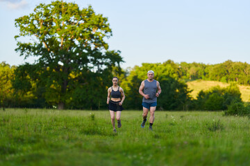 Fitness couple jogging in the forest