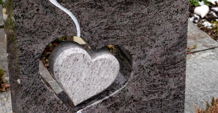 A stone heart sculped on a tombstone