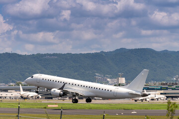 airplanes jet take off from runway on taxi lane in airport and aircraft traffic to take off with cityscape background, view from window air plane.
