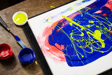 Abstract artistic painting on canvas. Brush and colors on the table