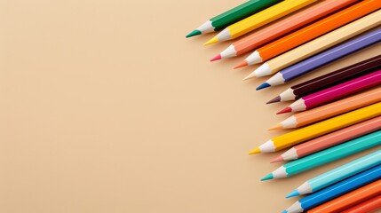 Top view of assorted color pencils and school supplies on a beige table, perfect for back-to-school backgrounds with copy space. 32k, high resolution