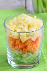 vegetables and fruits chopped for snacks in a glass