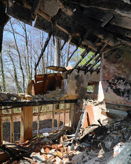 Fototapeta premium House completely destroyed with the roof collapsed after the terrible fire that burned everything